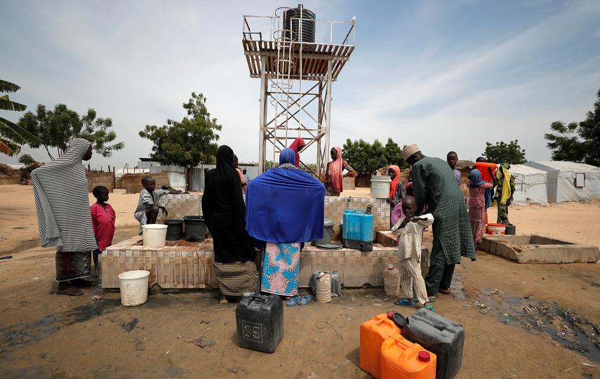Internally displaced people gather to fill their buckets at the water point in Muna Garage IDP camp in Maiduguri, Borno State, Nigeria October 23, 2022.